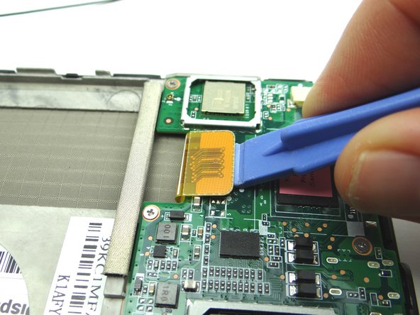 Picture 1: Use a wide blue pry tool to disconnect the LCD cable.