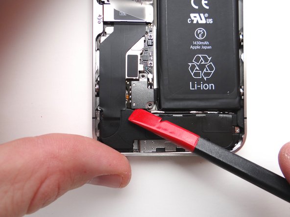 Picture 1: Place the flat end of the Black Spudger (tip is painted red for better illustration) at the bottom of the battery connector.  Twist the spudger counter-clockwise to lift the bottom of the connector from its socket.