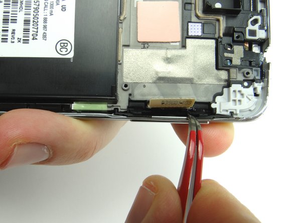 Use curved tip tweezers to press the button firmly into place.