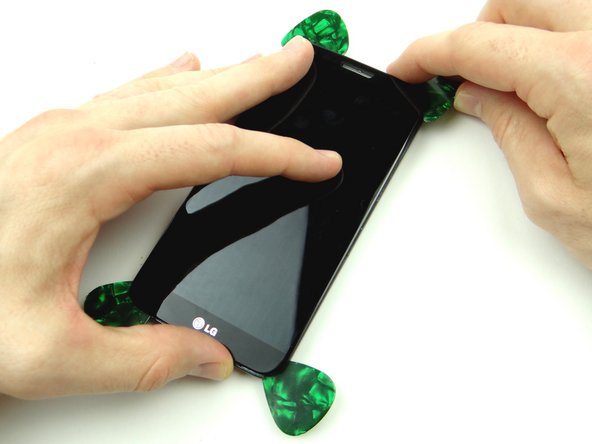 Picture 3: Work the guitar pick back up to the corner and start prying the display away from the mid-frame.