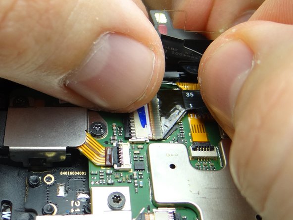 Guide component cable into open ZIF connector. Hold component cable in place with one hand, while closing ZIF connector with your thumb on opposite hand.