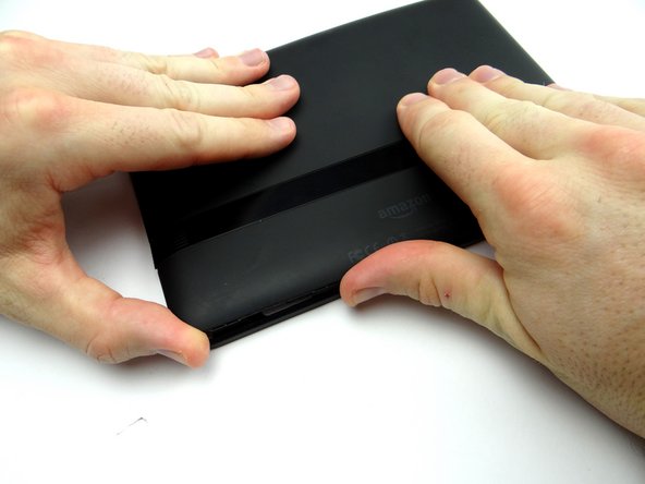 Push battery cover back onto Kindle.