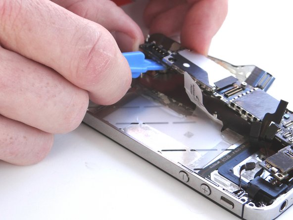 Picture 2: Once you have a good grip on the logic board, use your right hand to brush away cables near the top while pulling the logic board towards you until it is free from the mid-frame.  Place in ZONE III.