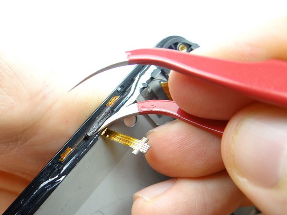 Use one prong of curved-tip tweezers to lift edge of the tape covering volume contacts cable.