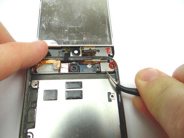 Picture 3: Remove the rear camera bracket and place into SLOT 6.  Avoid the tiny spring circled in red.