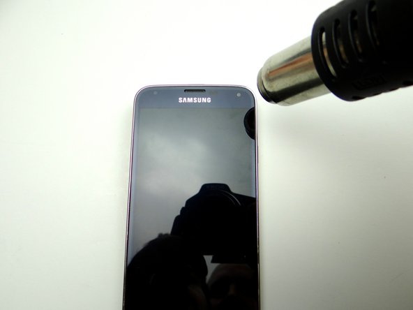 The screen is tightly adhered to the mid-frame with adhesive around its perimeter: