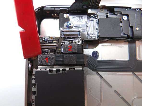 Picture 1: Release cables '1' and '2' just below the camera slot.  Use the Black Spudger to gently lift the connectors up and out of the sockets.