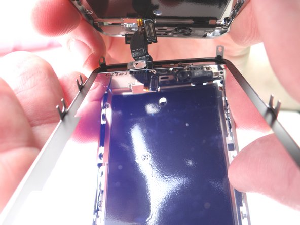 Continue pulling the display assembly away from the mid-frame until separated. Keep the broken display assembly on the scrap paper and set it off to the side (you may need to harvest parts from it).