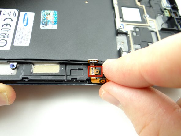 Seat the opening on the cable over the tab on the front panel.