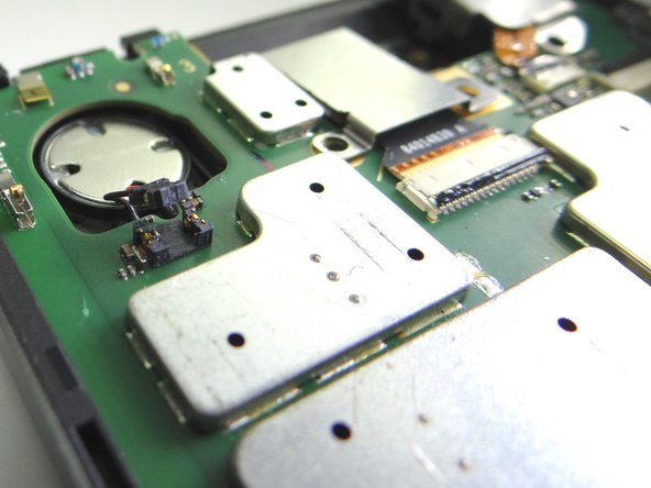 Picture 3: Be careful to pry up just the cable head (as shown) and not the socket on the logic board.