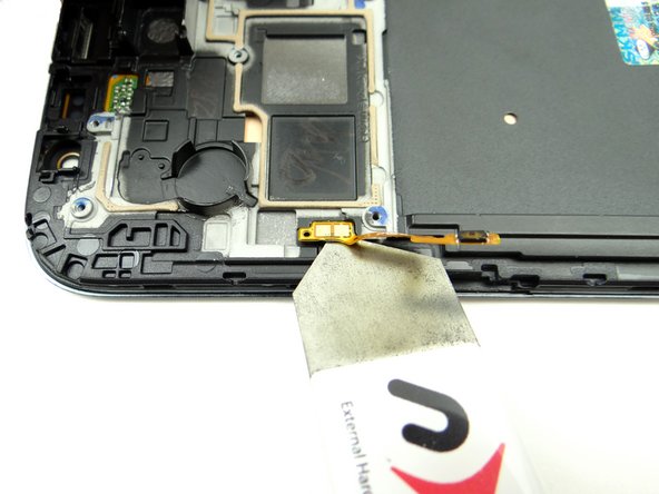 Picture 2: Wedge the spudger under the power button.  Lift the power button while using your thumb on the opposite hand to help control the movement.  Stop when you reach the contact pad.