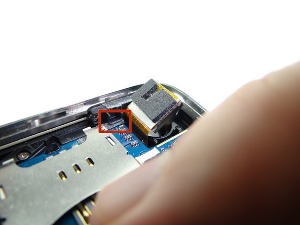 Picture 3: Hold the charging port cable out of the way while seating the bottom of the logic board.