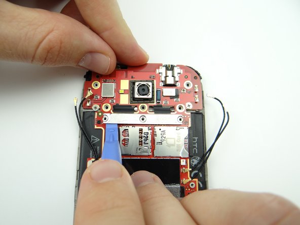 Lift the left and right sides of the silver connector bar.