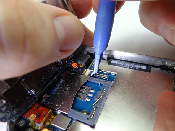 Pictures 2 &amp; 3: Use the blue pry tool to flip the ZIF connector into the upright 'open' position to release the ribbon cable marked '3'.