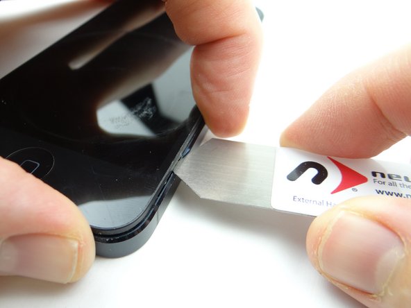 Picture 3: Slowly rotate the iSesamo in one hand while pinching the screen with your opposite hand.  Lift just enough to insert the blue pry tool in the lower-right corner.