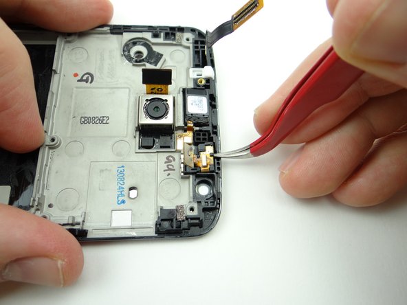 With the tweezers in the closed position, wedge under the sensor and lift slightly.