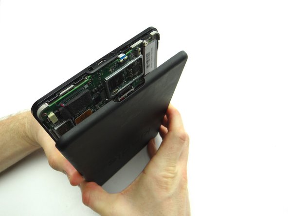 With the Kindle upside down (charging port at top), use your hands to separate the battery cover from the Kindle.  Start at the charging port and work your way down.