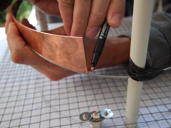 Using the brass triangle as a guide mark the end of the wire