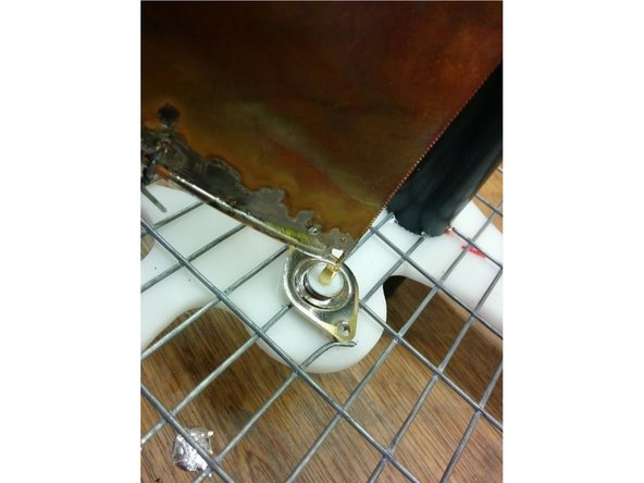 Insert the small tip of the triangular copper sheet in the N-type connector and solder.