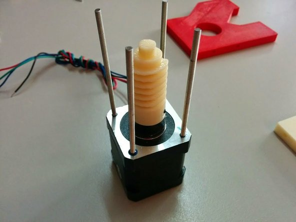 Apply Thread Glue to one side of each threaded rod and screw them on all 4 sides of the Stepper Motor