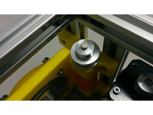 Using some cyanoacrylate glue, fix the magnet over the center of the pulley that is over the worm gear