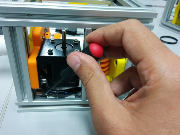 Loose the screws on the hidden corners in a way that stepper motor can slide towards the worm gear.