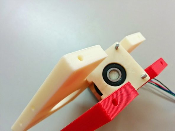 Install the Axis Sides on the threaded rods, and place the Bearing Holder cap on top of them as shown, making sure that the notch is facing as shown.