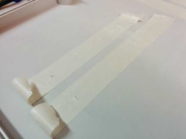 Place the cover of the box carefully and remove it to see the tape stuck underside with holes marked.