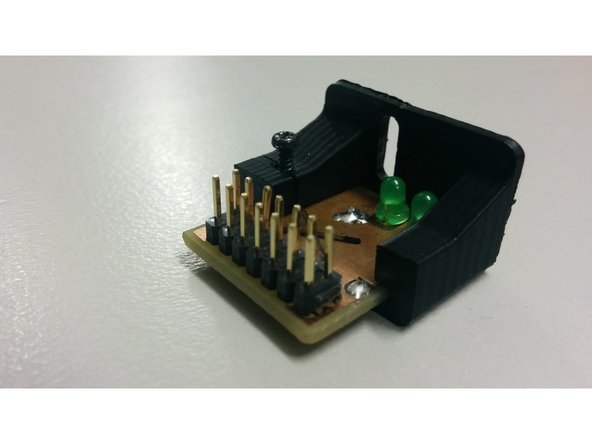 Slide The pcb into the 3D printed part and use the M2 screw to gently hold it in place