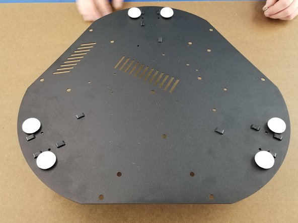 The rubber feet are a press fit over the black plastic feet.