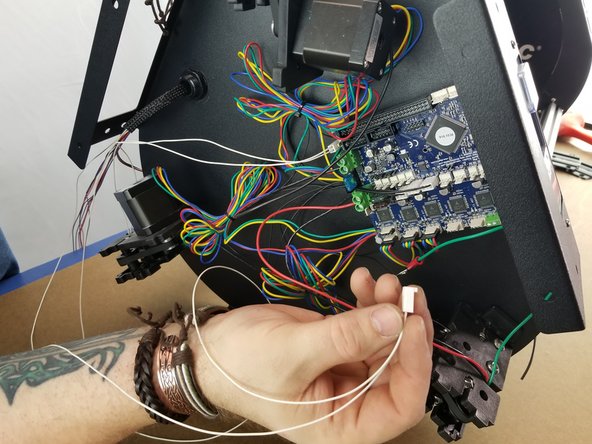 Here you will plug in the hotend thermistor to the Duet.  It is the white 2 pin connector you just installed on the whip with the two white wires in it.