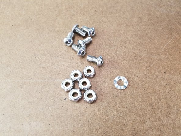 This step will use the 6x 1/4-20 x 1/2&quot; long button cap screws, 6x thin nylon lock nuts, and one spike grounding washer.