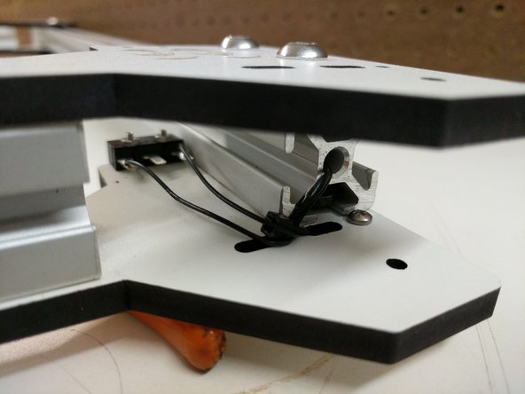 Use one of the supplied zip-ties to secure the end-stop wires to the laser cut piece (same side as end-stop)