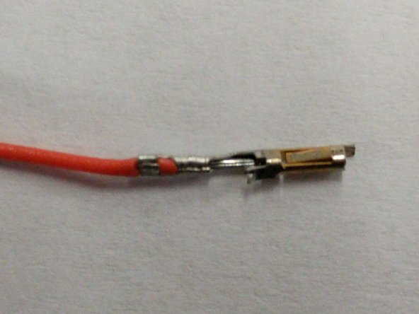 Insert the wire into the connector as shown. The wire should be inserted such that the insulation will be captured by the crimp as indicated with a blue arrow and the stranded wire will be capture as indicated with a green arrow.
