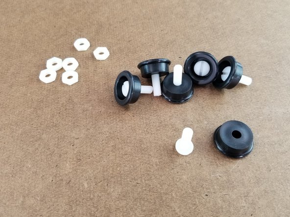 Insert the nylon screws into the black plastic feet so the head of the screws goes inside the feet as shown in the first pic.  Do this to all 6 screws and feet.