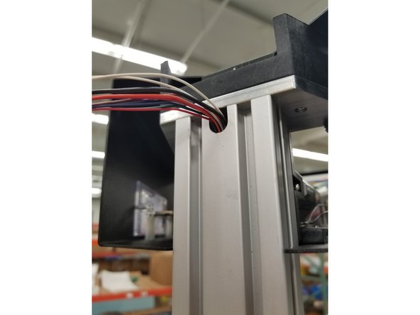 Pull the wires through the tower until the mesh loom enters the hole in the tower and there is enough wire to reach all the connection points in the top assembly when wrapped around the tower.