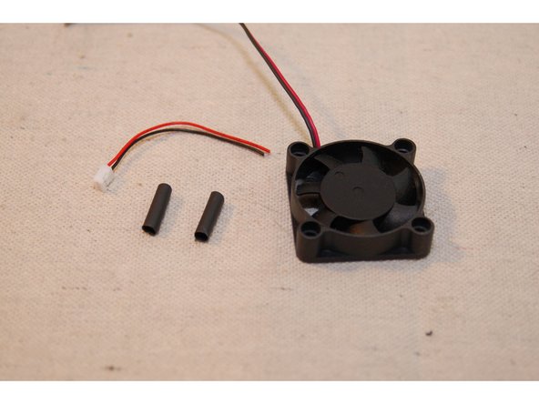 For this task, you'll need the 30mm length of heat shrink tubing, the connector you clipped from one of your 25mm cooling fans and the 40mm Rambo cooling fan, as shown.