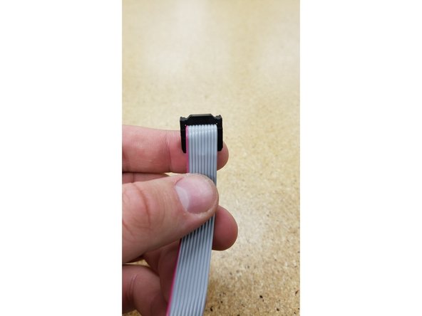 Hold the loose end of the ribbon cable and fold it exactly as shown in photos 1, 2, and 3.