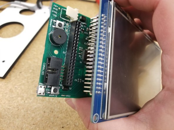 Install the  PanelDue control board  on the touch screen as shown. Be sure the pins all align and plug in fully.
