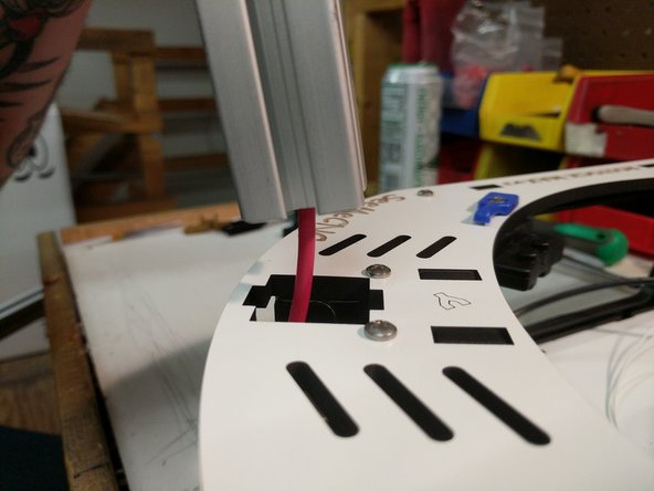 Route the wire through the base top plate as shown.