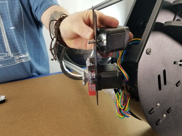 Grab your 26506 NEMA 17 Stepper Motor and place it on the back of the plate with the wires facing the center, just as the existing motor is installed.