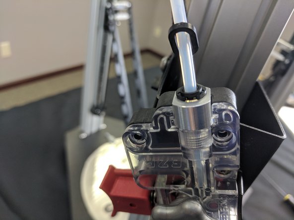 Lift up on the black ring in the top of the hot end and slide the PTC clip into the groove between the black ring and the aluminum adapter.