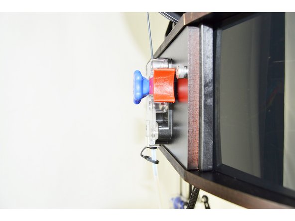 The extruder on a 3D printer, is the device that feeds the filament to the hot end. On the RMAX v3, the extruder is called the EZR Struder. It is the component on the side of the top assembly that has a clear cover, black base and red release lever.
