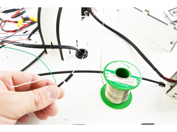 Slide a piece of 15mm long heat-shrink tubing over one of the wires.