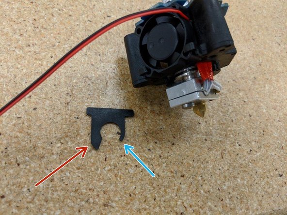 Insert the barrel fan blocker between the last two heat sink fins at the bottom of the hot end.