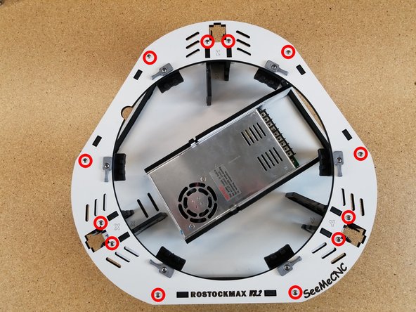 Start in one area and align the tabs in the injection molded components with the cutouts in the laser cut plate. When aligned press down and continue to work your way around the plate until it is fully seated on the injection molded components.
