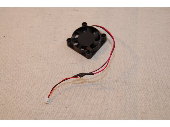 Slip the heat shrink on to the fan leads and then solder the connector to the fan leads.