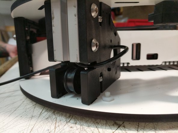 Route the wire through the base top plate as shown.