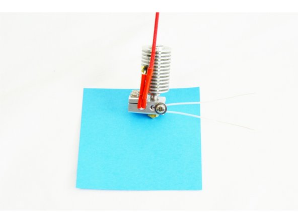 Insert the #4 washer onto the M3 screw (sharp edges facing the head of the screw), and then insert the screw into the hole (furthest from the heater cartridge) in the side of the heater block.