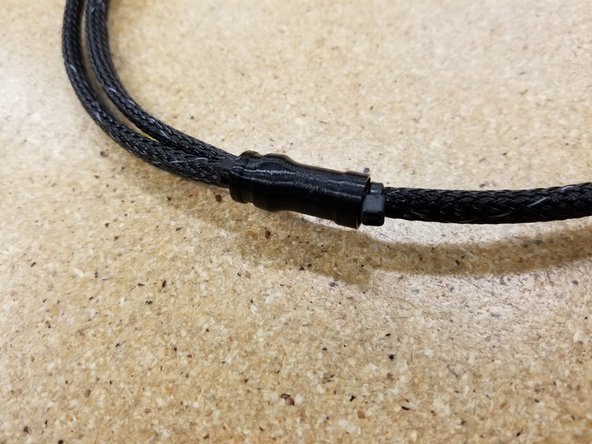 Add a zip tie to the mesh loom, just above the loom splitter, to secure it in place. See photo for reference.